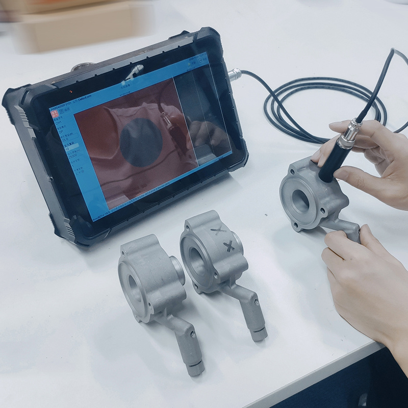 CC100 portable eddy current instrument connected to a handheld probe